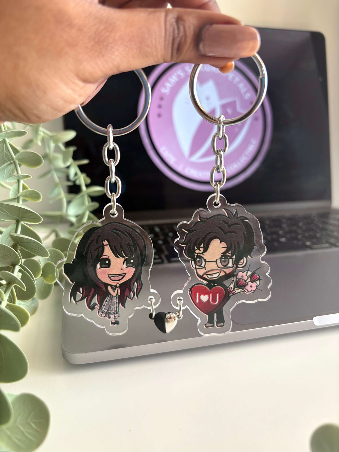 Hand-drawn personalised gift keychain of a couple with a heart charm.