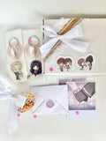 Anime Couple Gift Hamper in soft white packaging with keychain, polaroids, chocolates, letter, and anime couple stickers