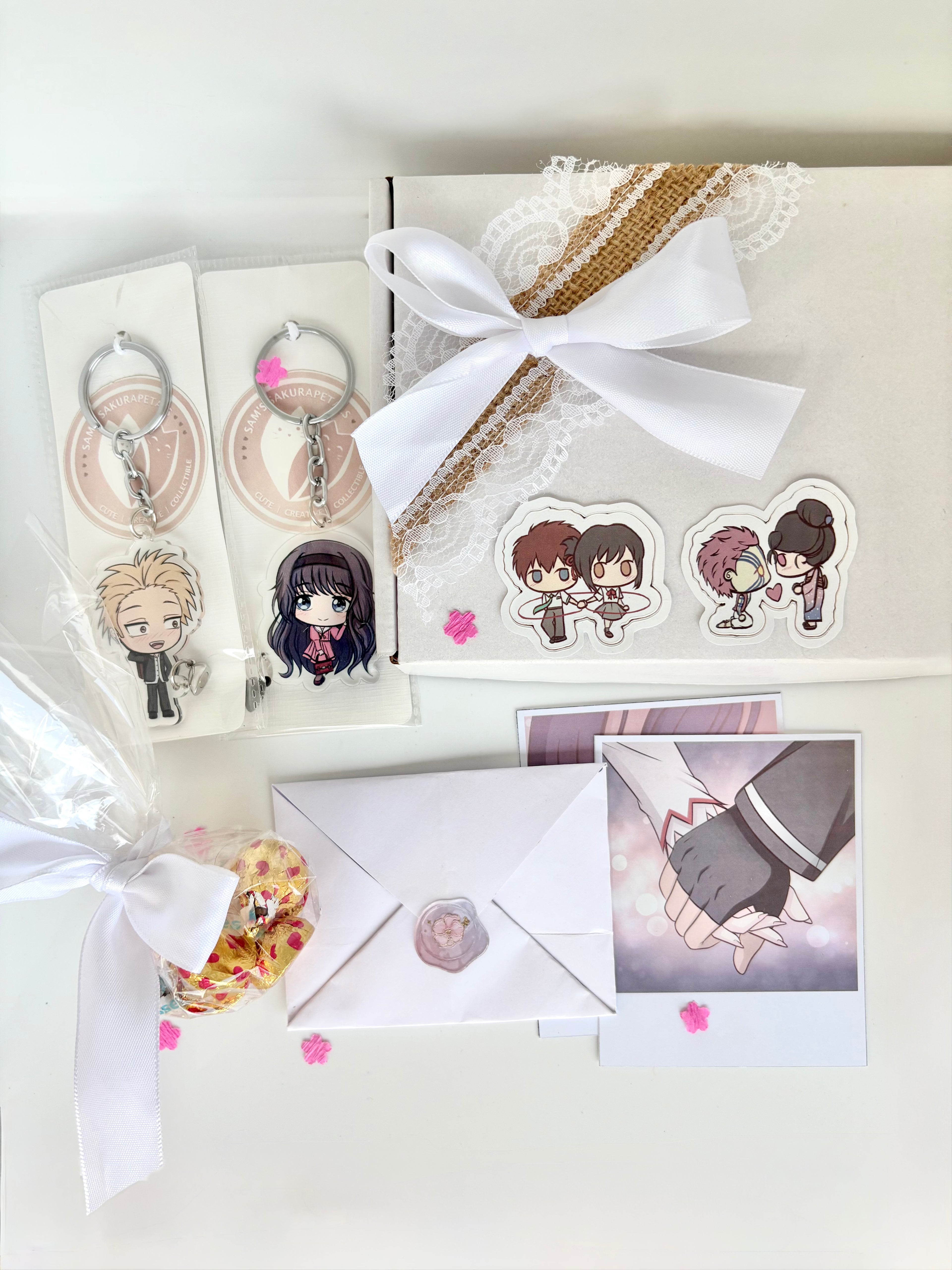 Anime Couple Gift Hamper in soft white packaging with keychain, polaroids, chocolates, letter, and anime couple stickers
