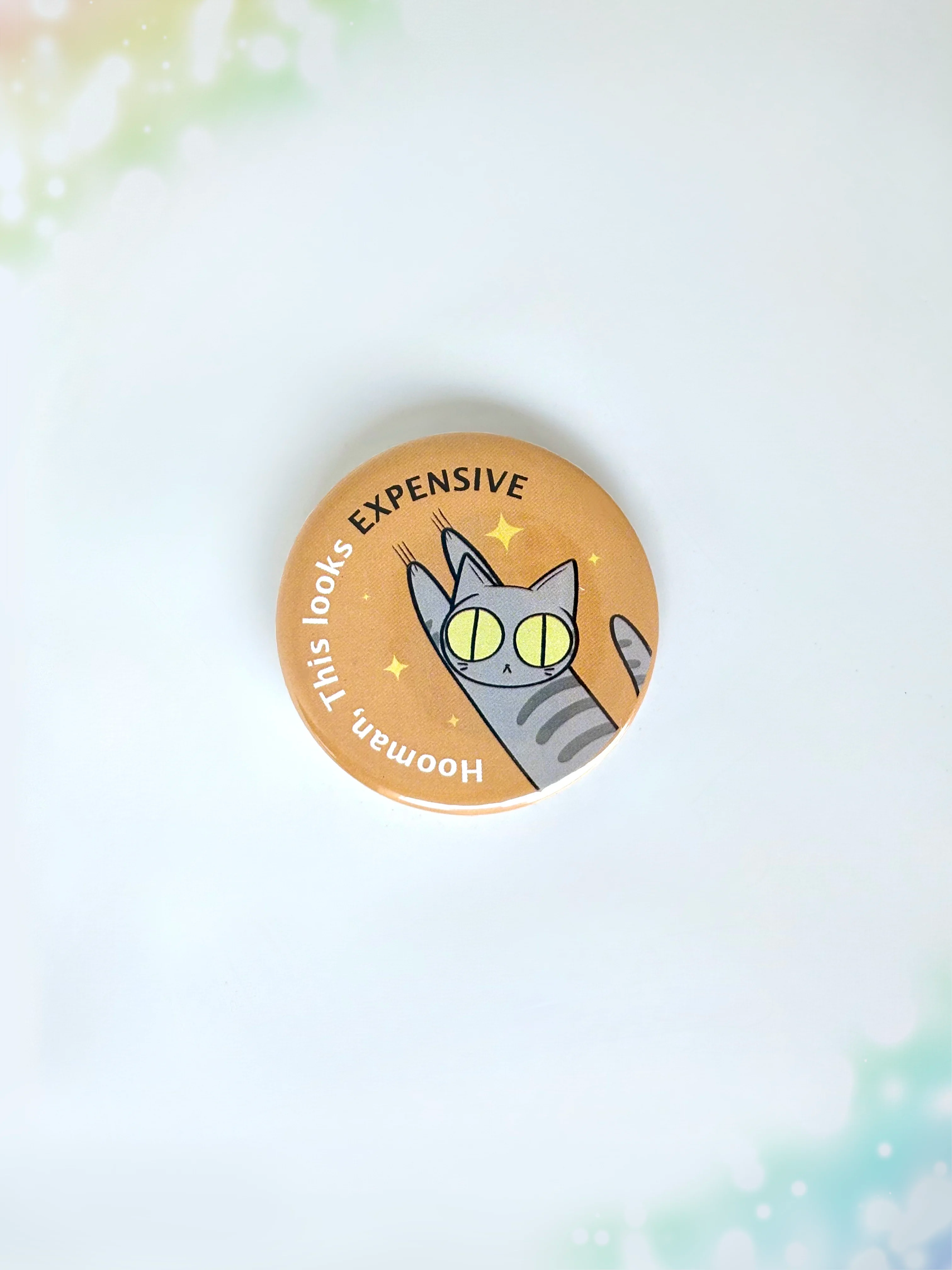 Funny mischievous cat button badge featuring a kitty knocking something over with the text Hooman This Looks Expensive.