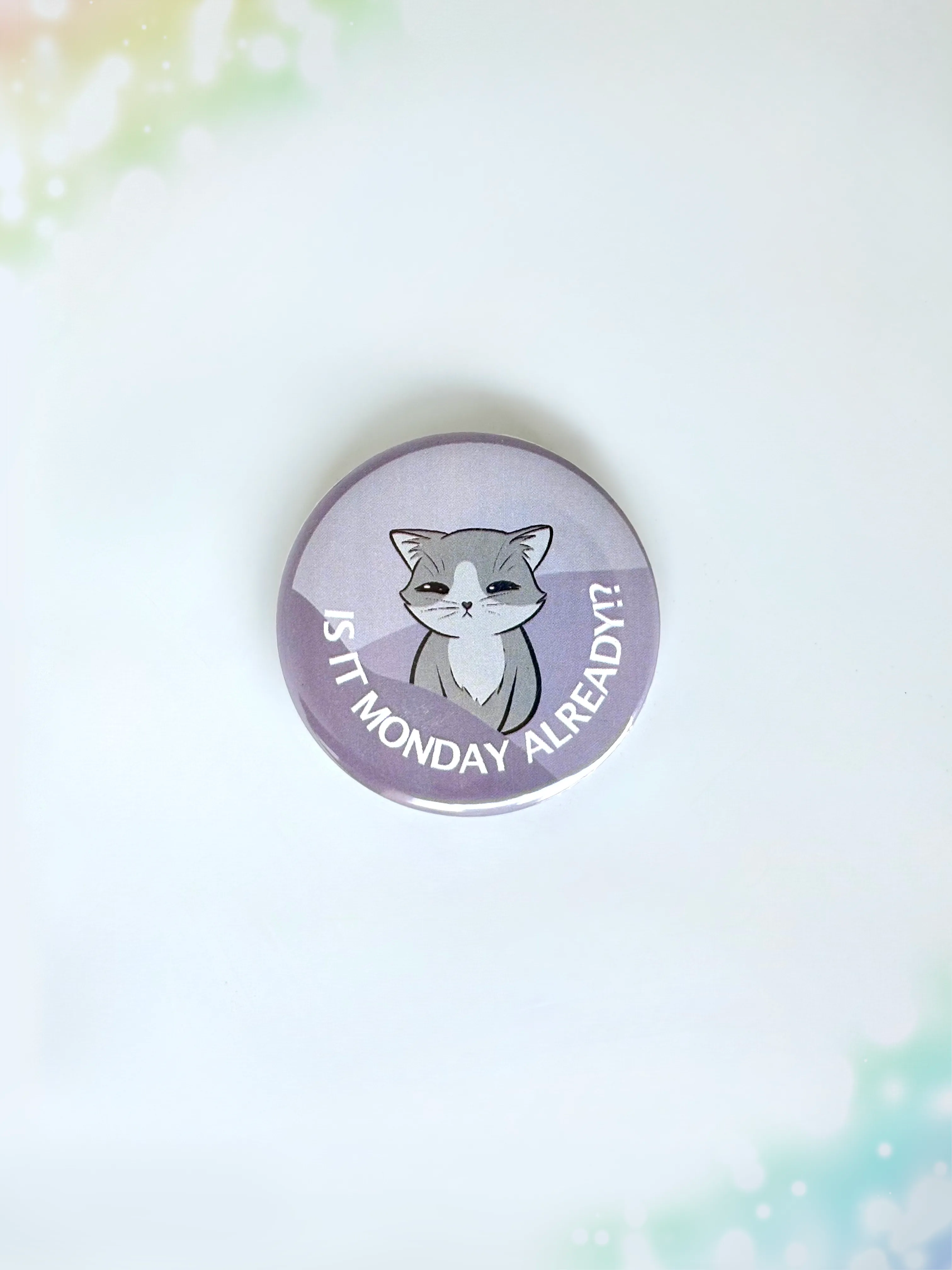 Funny cat merch button badge showing a tired kitty with the text Its Monday Already.