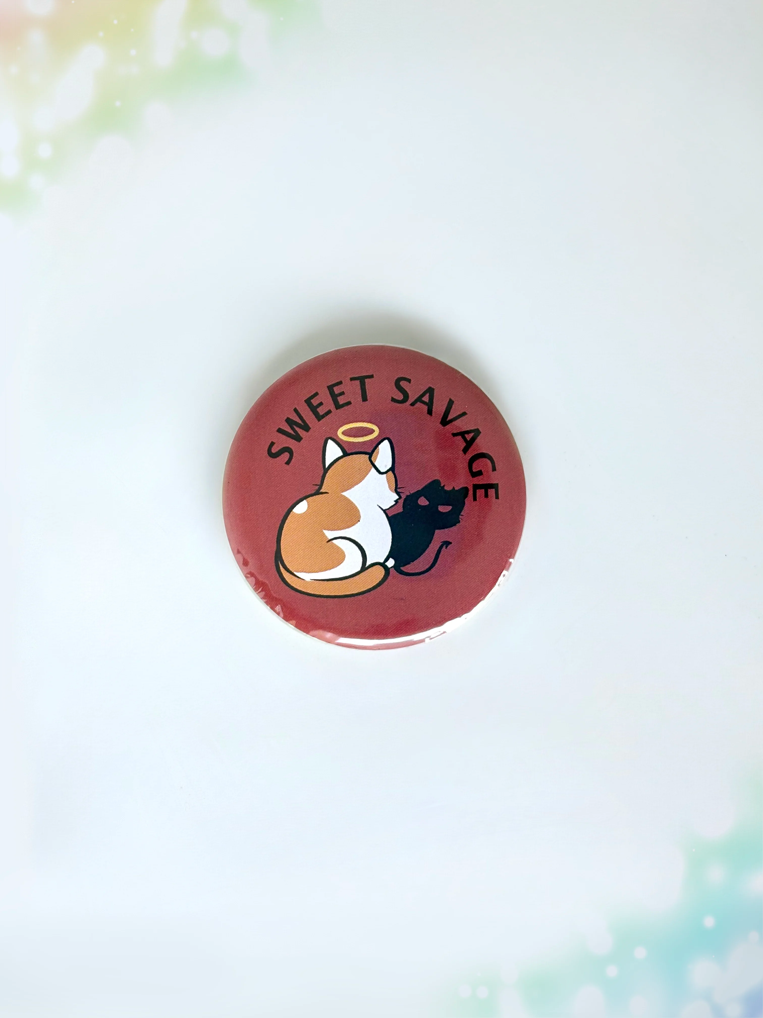 Chibi cat illustration button badge with the text Sweet Savage.