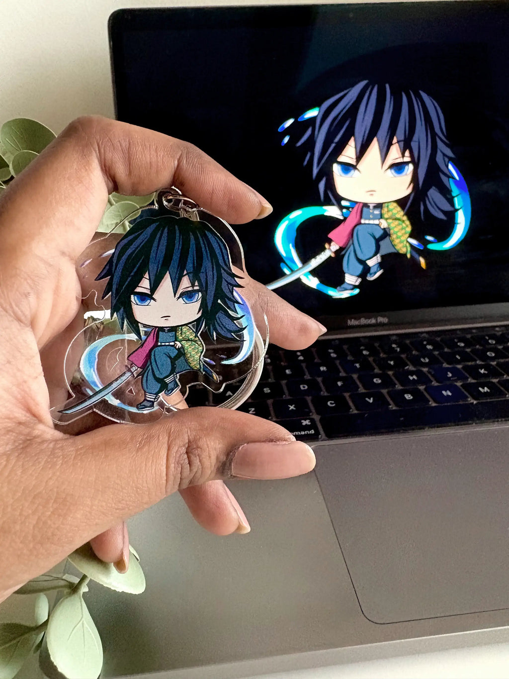Giyu Tomioka fanmade acrylic anime keychain held in hand