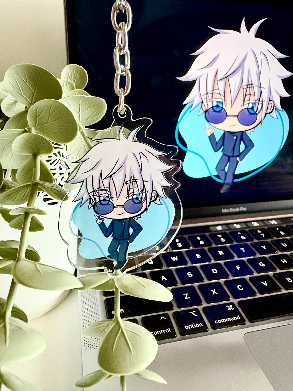 Gojo Satoru acrylic anime keychain held in hand