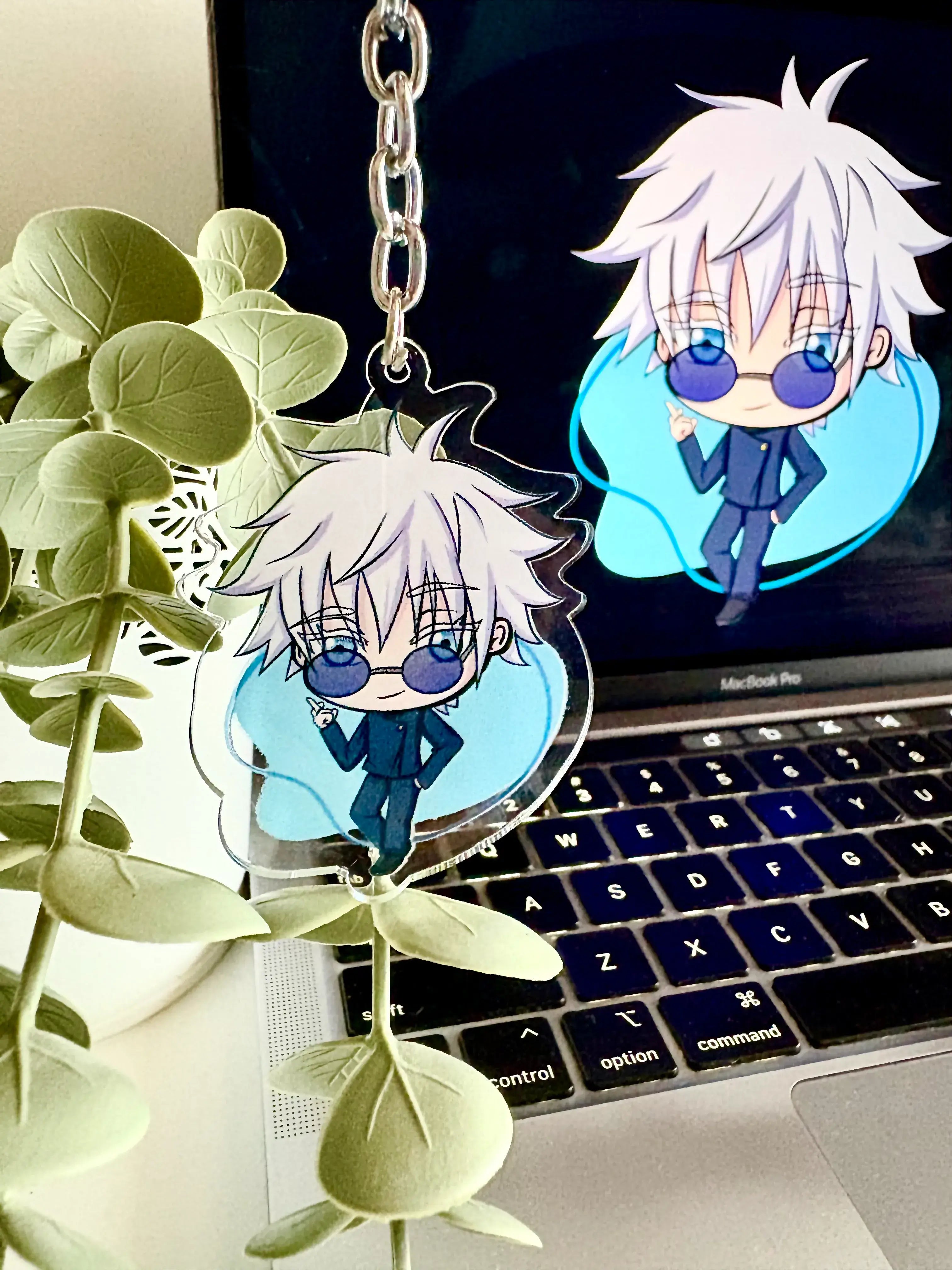 Gojo Satoru acrylic anime keychain held in hand