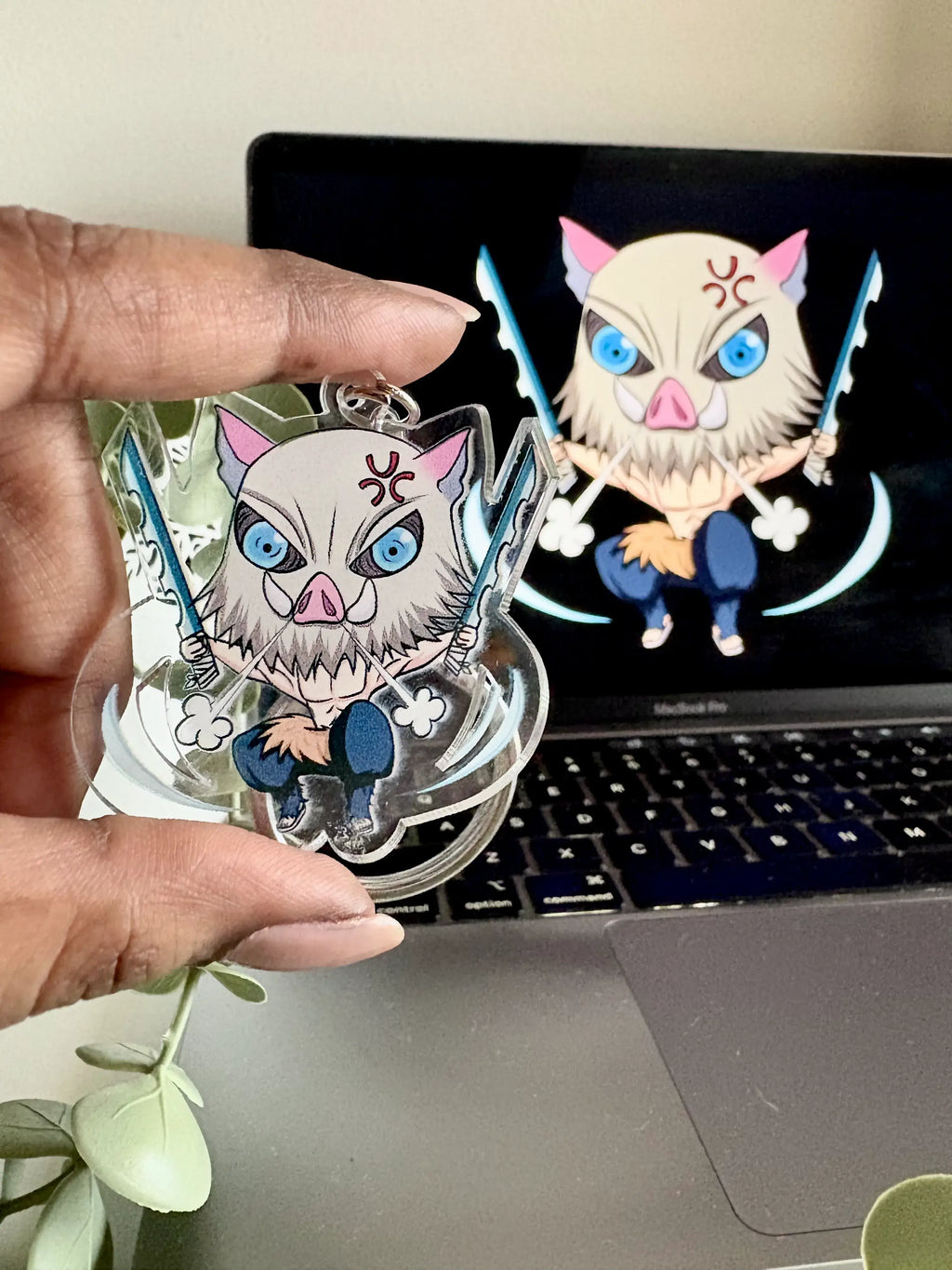 Inosuke Hashibira fanmade acrylic anime keychain held in hand