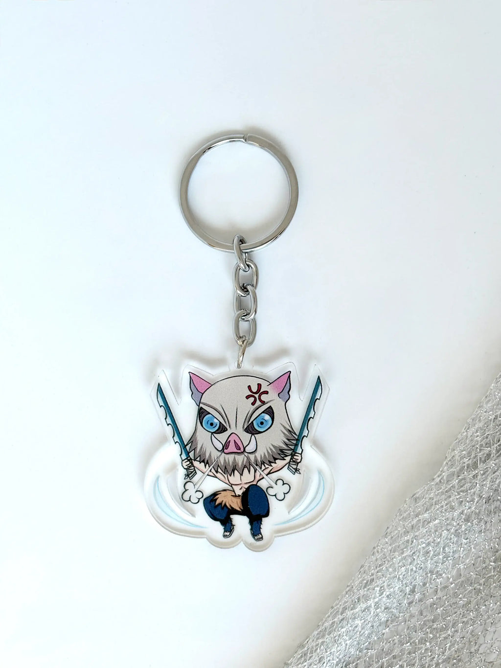 Inosuke Hashibira fanmade acrylic anime keychain on a plain white background