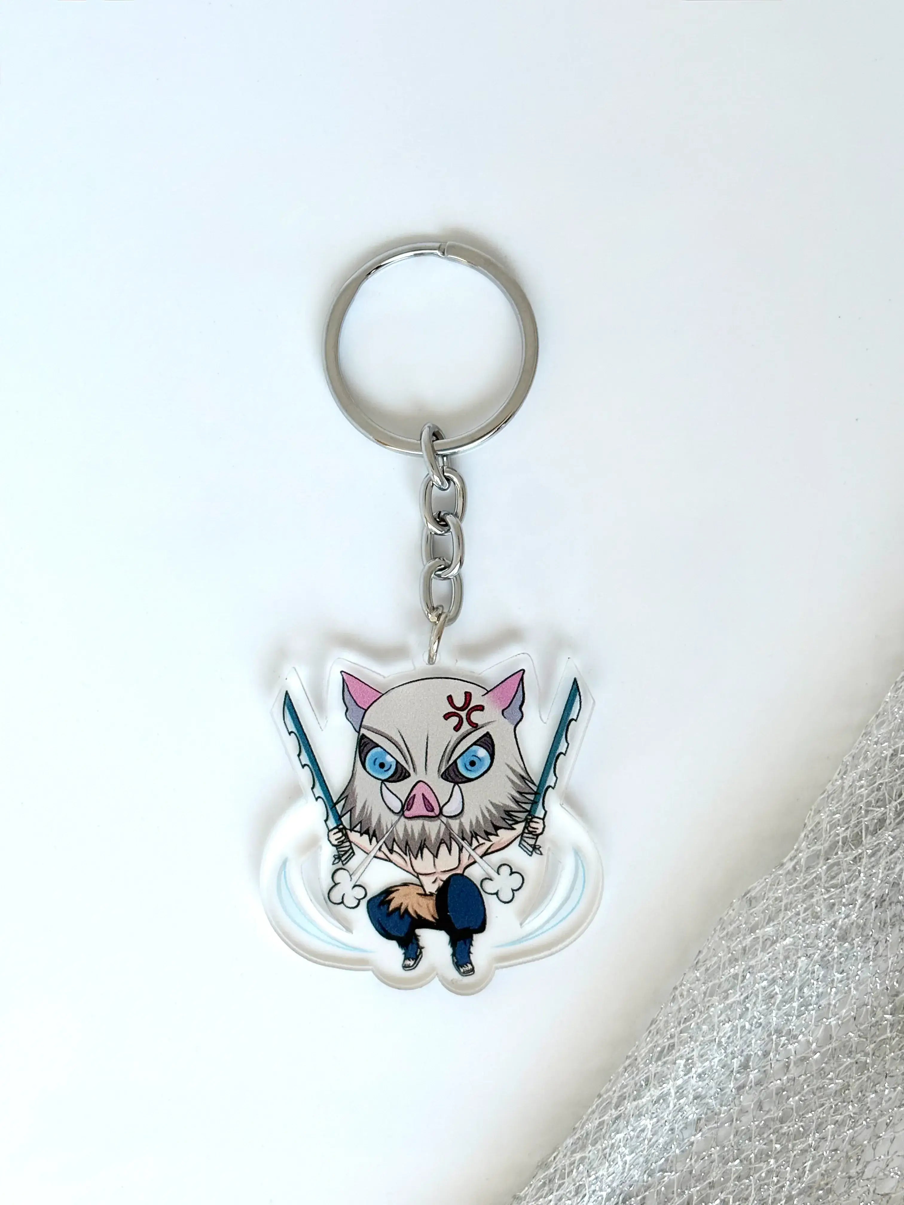 Inosuke Hashibira fanmade acrylic anime keychain on a plain white background