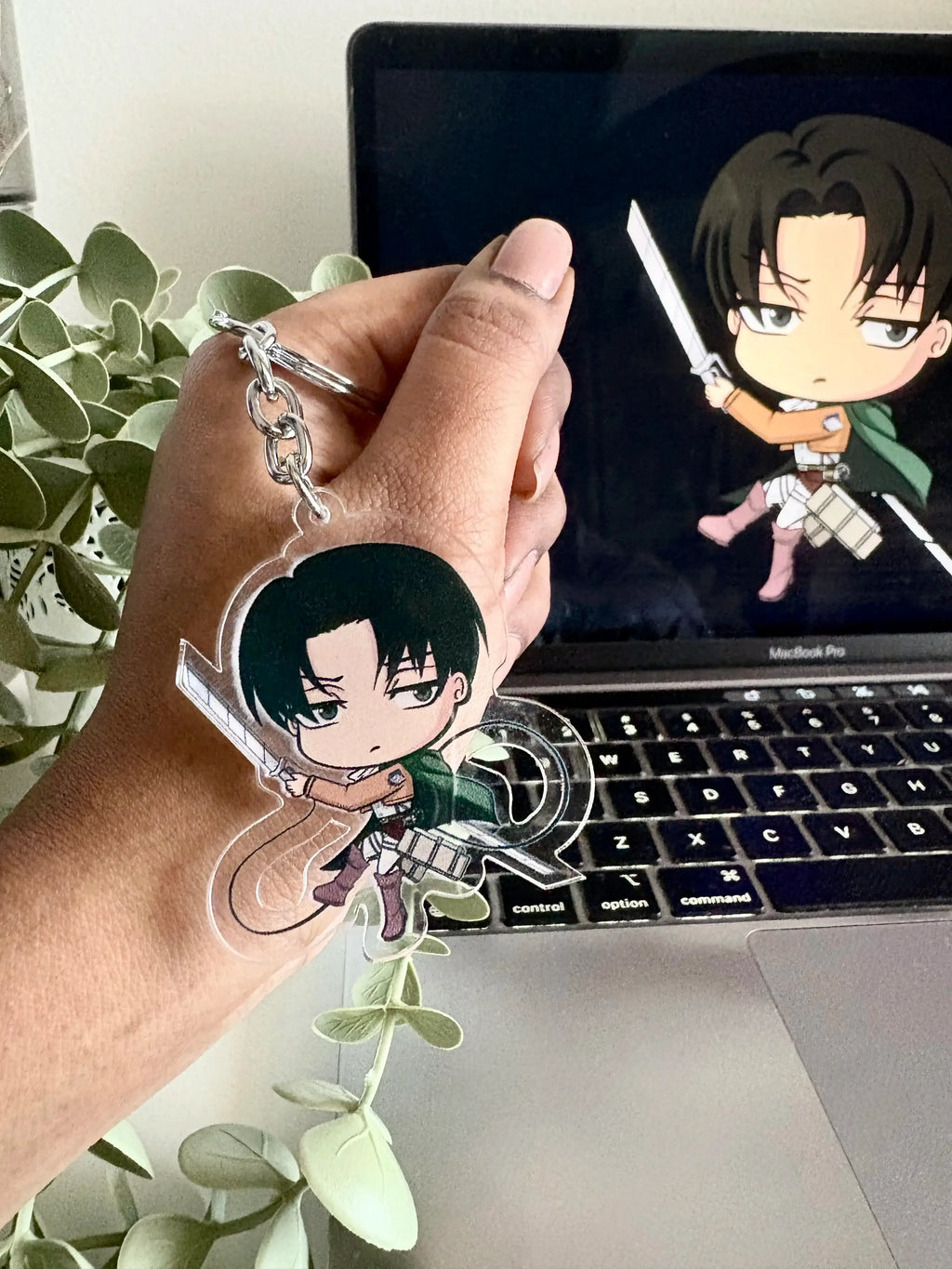 Levi Ackerman acrylic anime keychain held in hand
