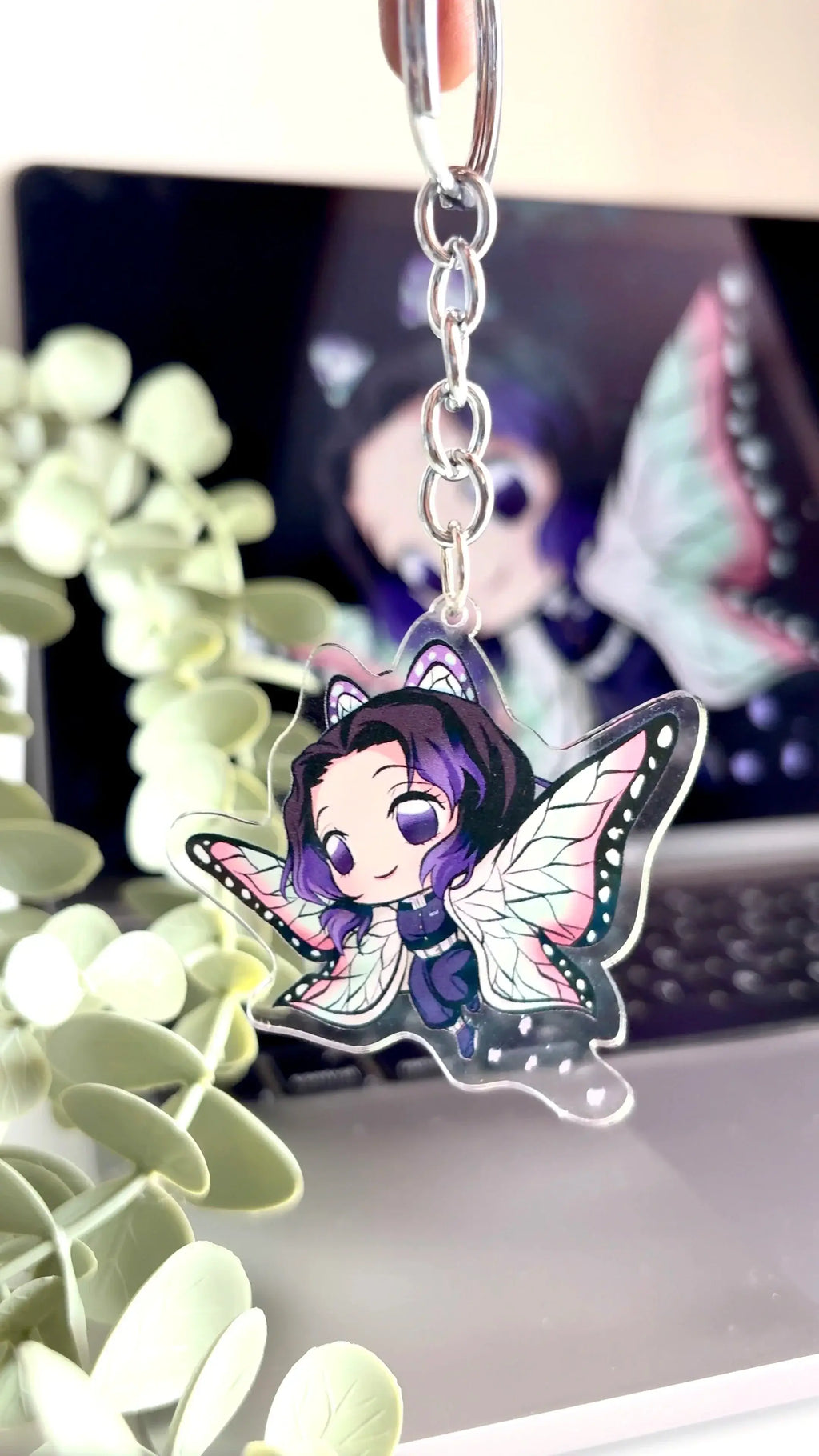 Holding Shinobu acrylic anime keychain in hand with natural lighting