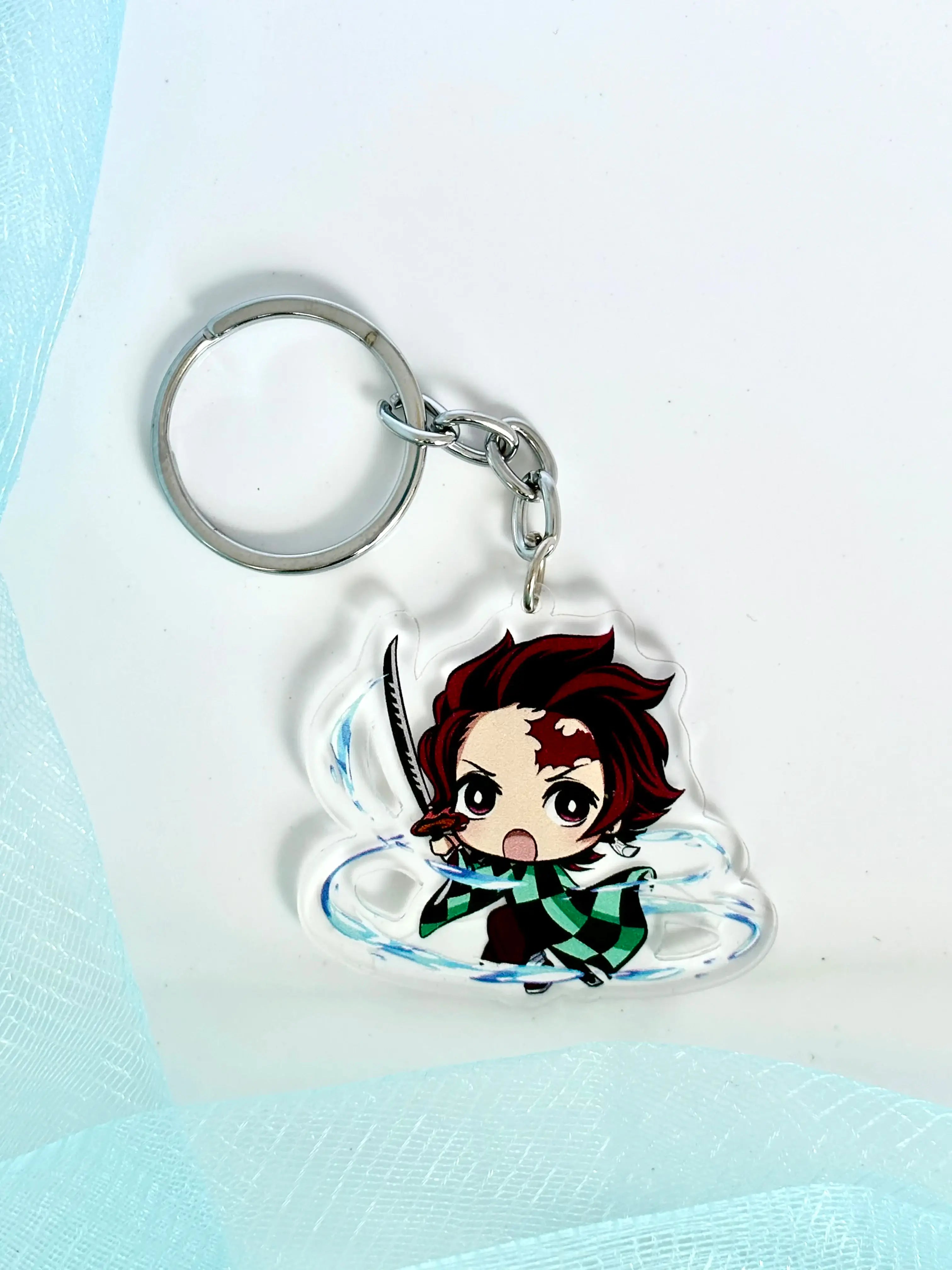 Fanmade Tanjiro Kamado acrylic keychain for Demon Slayer fans. Durable, high-quality charm for anime lovers. Limited stock at Sam’s Sakurapetals!