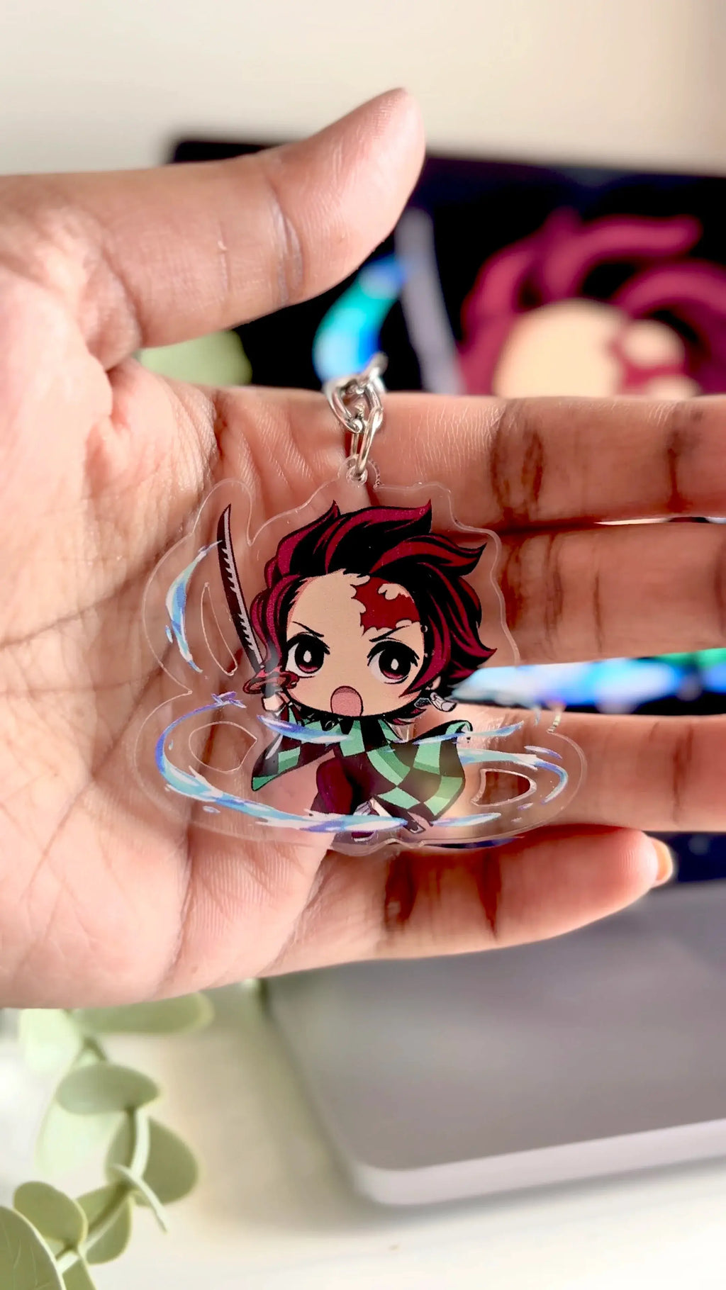Holding Tanjiro acrylic anime keychain in hand with natural lighting