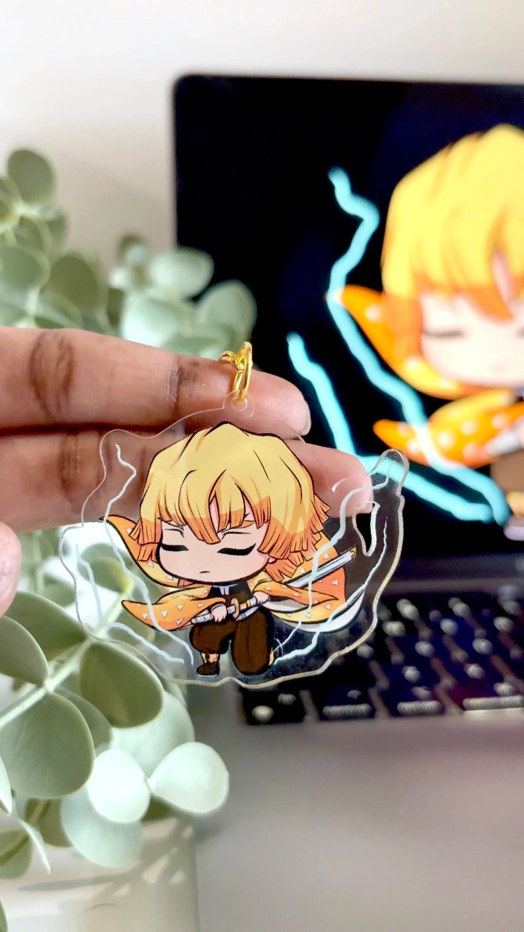 Holding Zenitsu acrylic anime keychain in hand with natural lighting